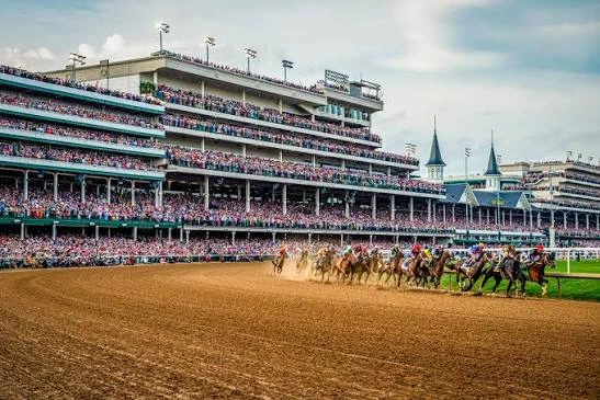 Thoroughbred horses race past packed grandstands at Churchill Downs.